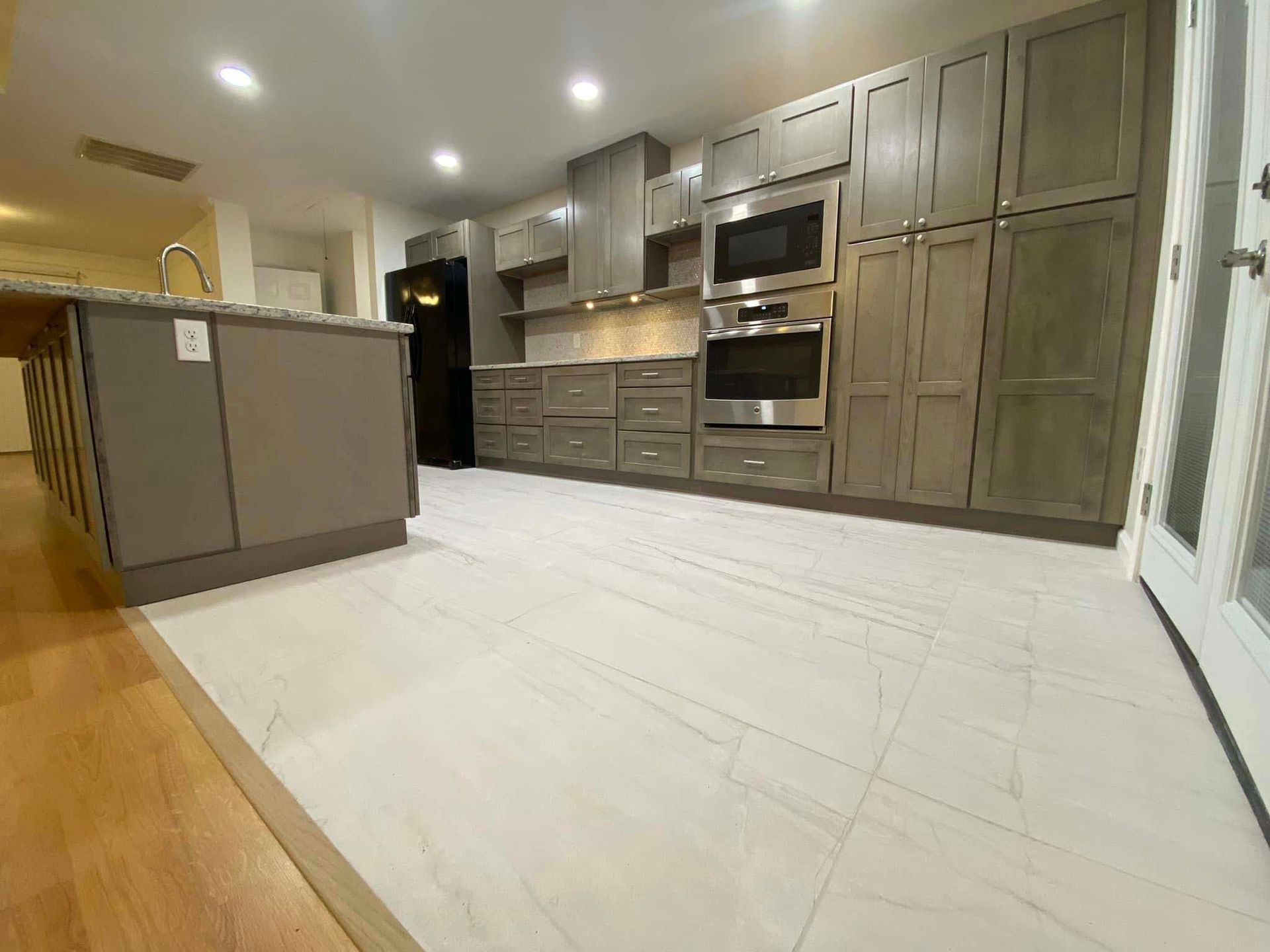 A kitchen with stainless steel appliances and wooden cabinets.