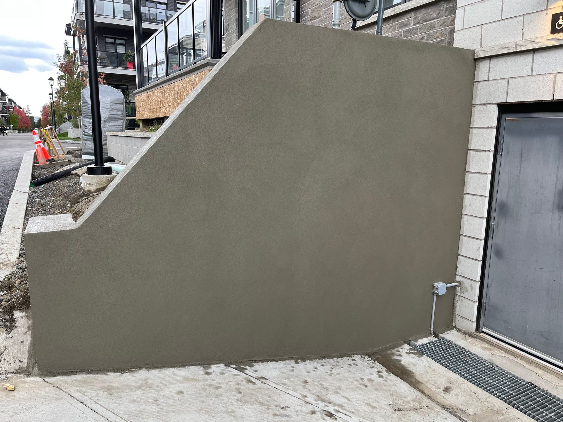 Un mur en béton est en cours de construction à côté d'une porte de garage.