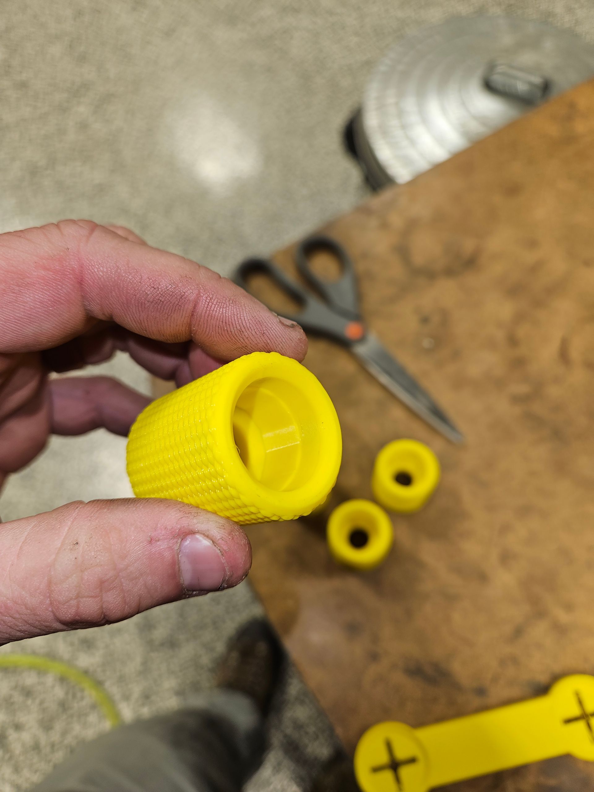 A person is holding a yellow object in their hand