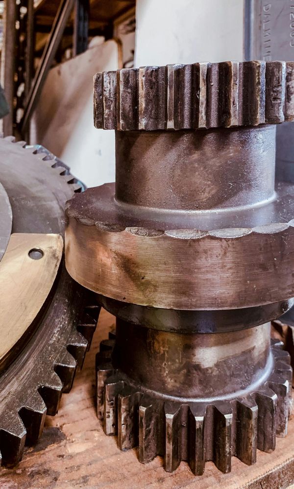 A close up of a gear on a wooden table.