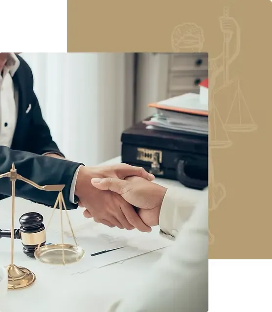 A man and woman are shaking hands at a table with scales of justice.