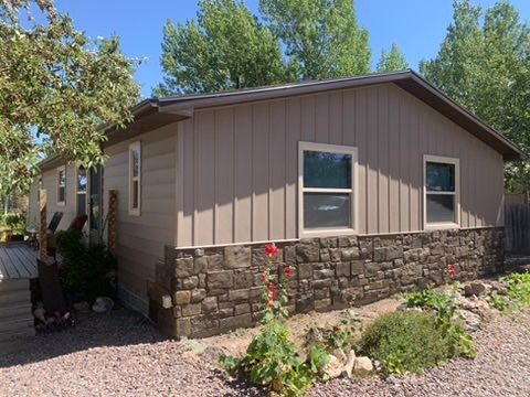 A mobile home with a stone wall and a lot of windows