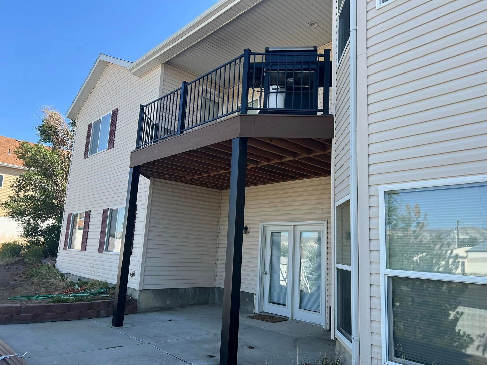 A house with a large deck on the side of it.