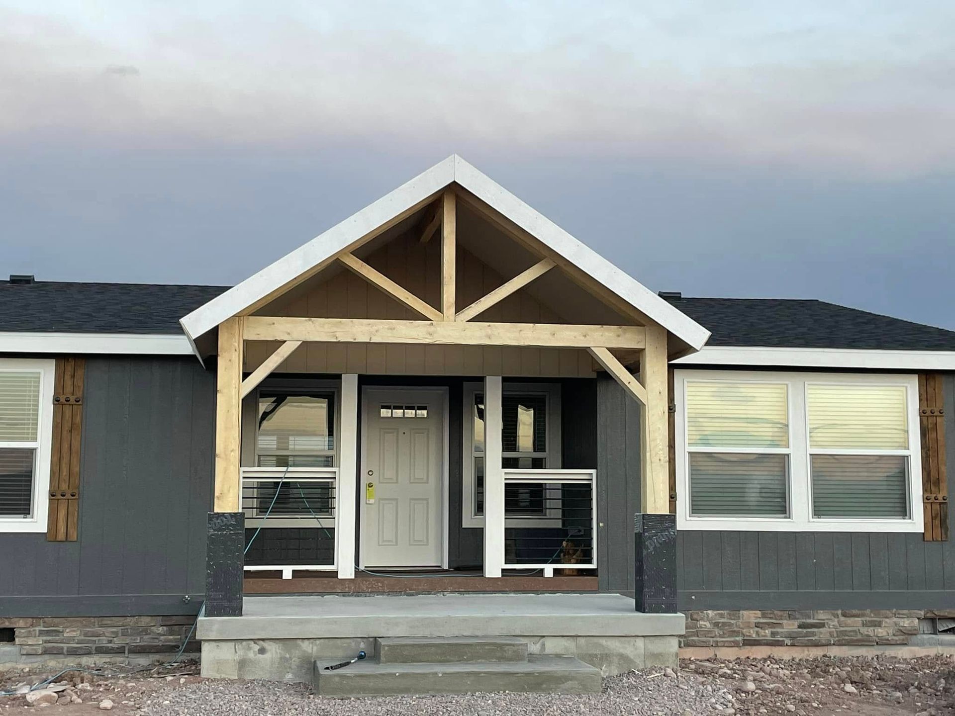 The front of a house with a porch and stairs.