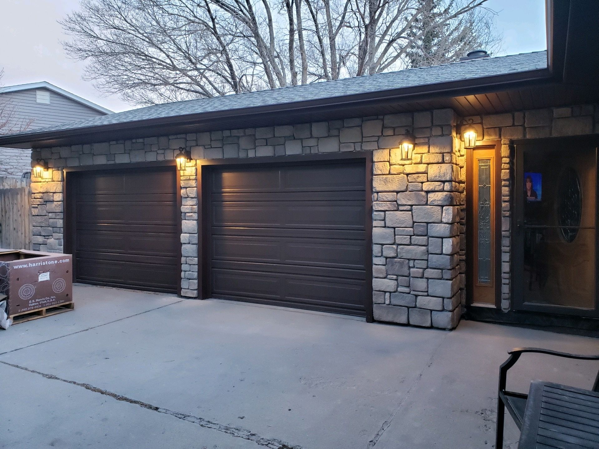 A close up of a roof with a chimney and trees in the background.