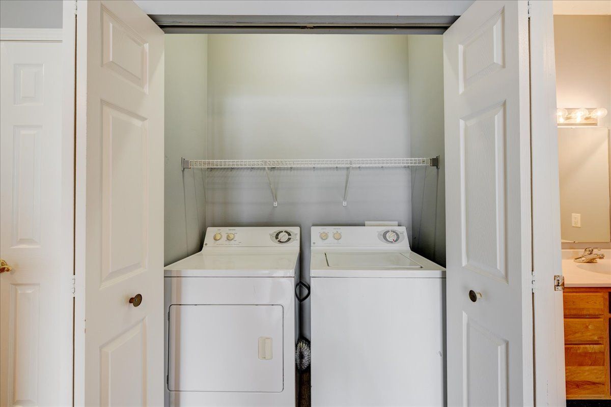 A laundry room with a washer and dryer in a closet.