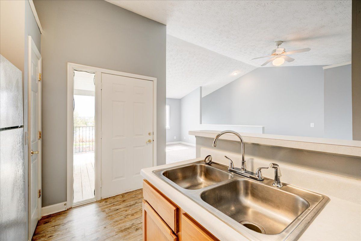 A kitchen with two sinks and a refrigerator.