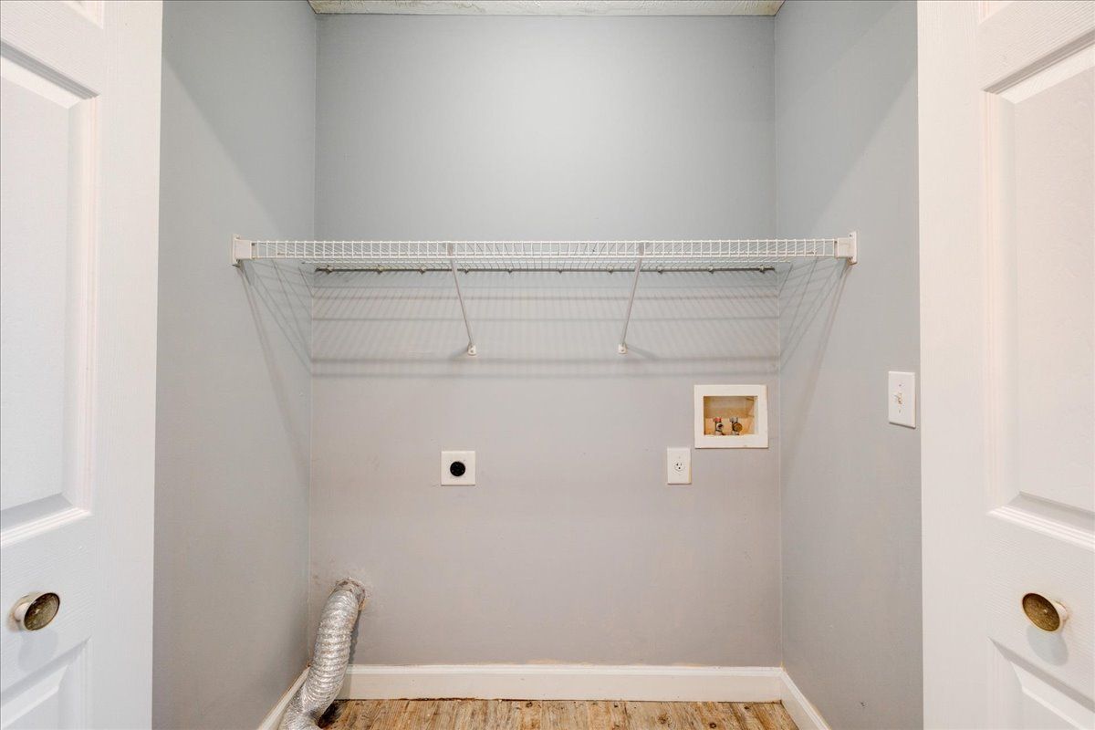 There is a laundry room with a washer and dryer in it.