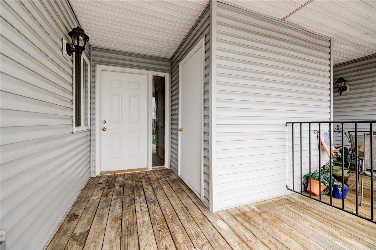 A house with a wooden deck and a white door