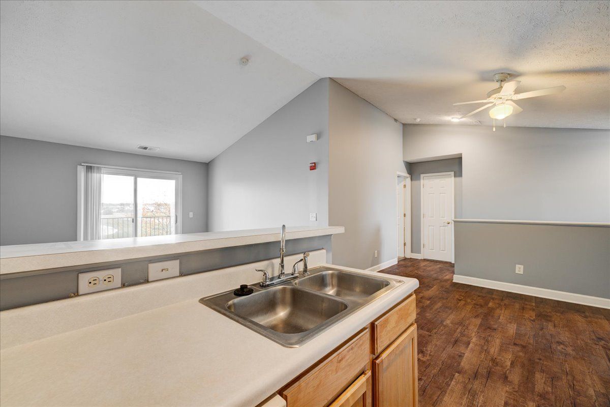 A kitchen with two sinks and a ceiling fan.