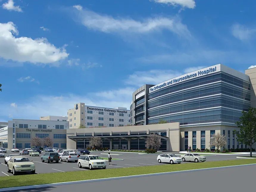 An artist 's impression of a hospital with cars parked in front of it
