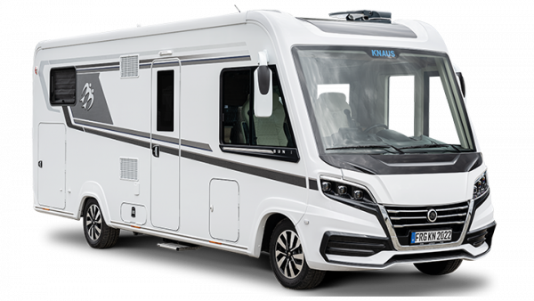 White motorhome with black accents, parked outdoors, on a sunny day.