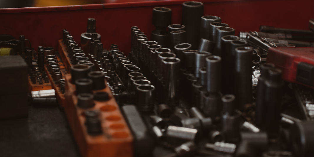 Close-up of a toolbox with various sockets and tools organized inside.