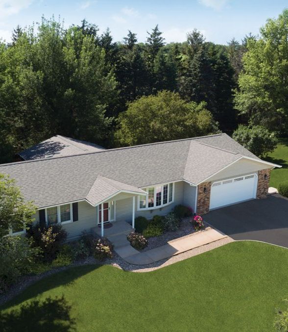 An aerial view of a house with a gray roof