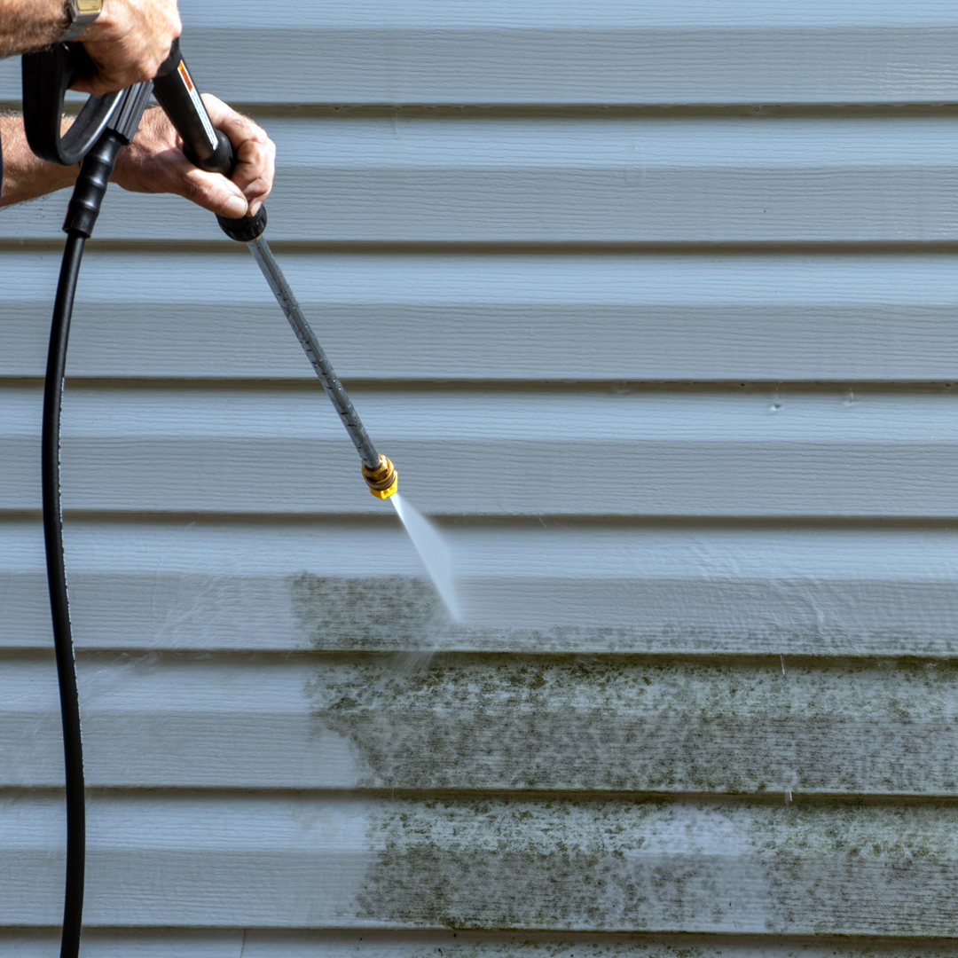 power washing the siding of a house