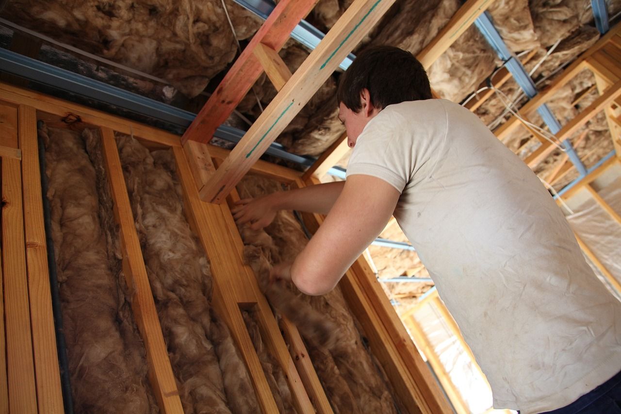 A man is installing insulation in a Stroud house