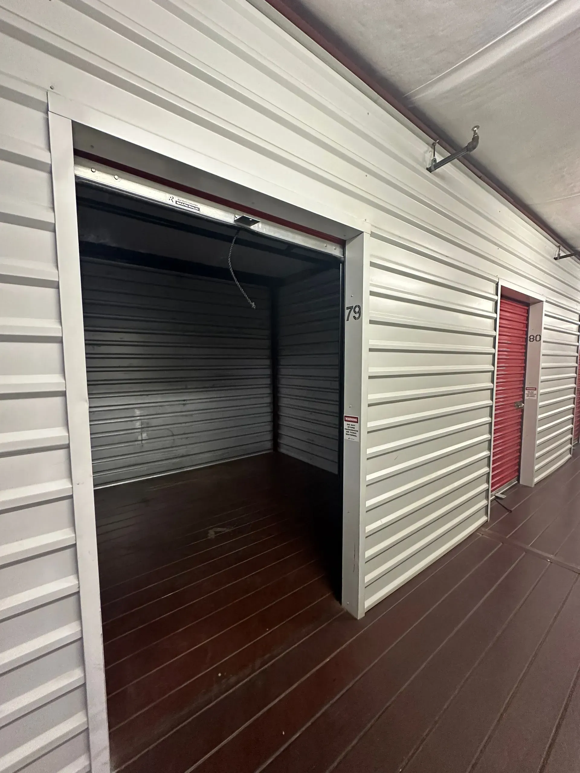 A row of empty storage units with the doors open.