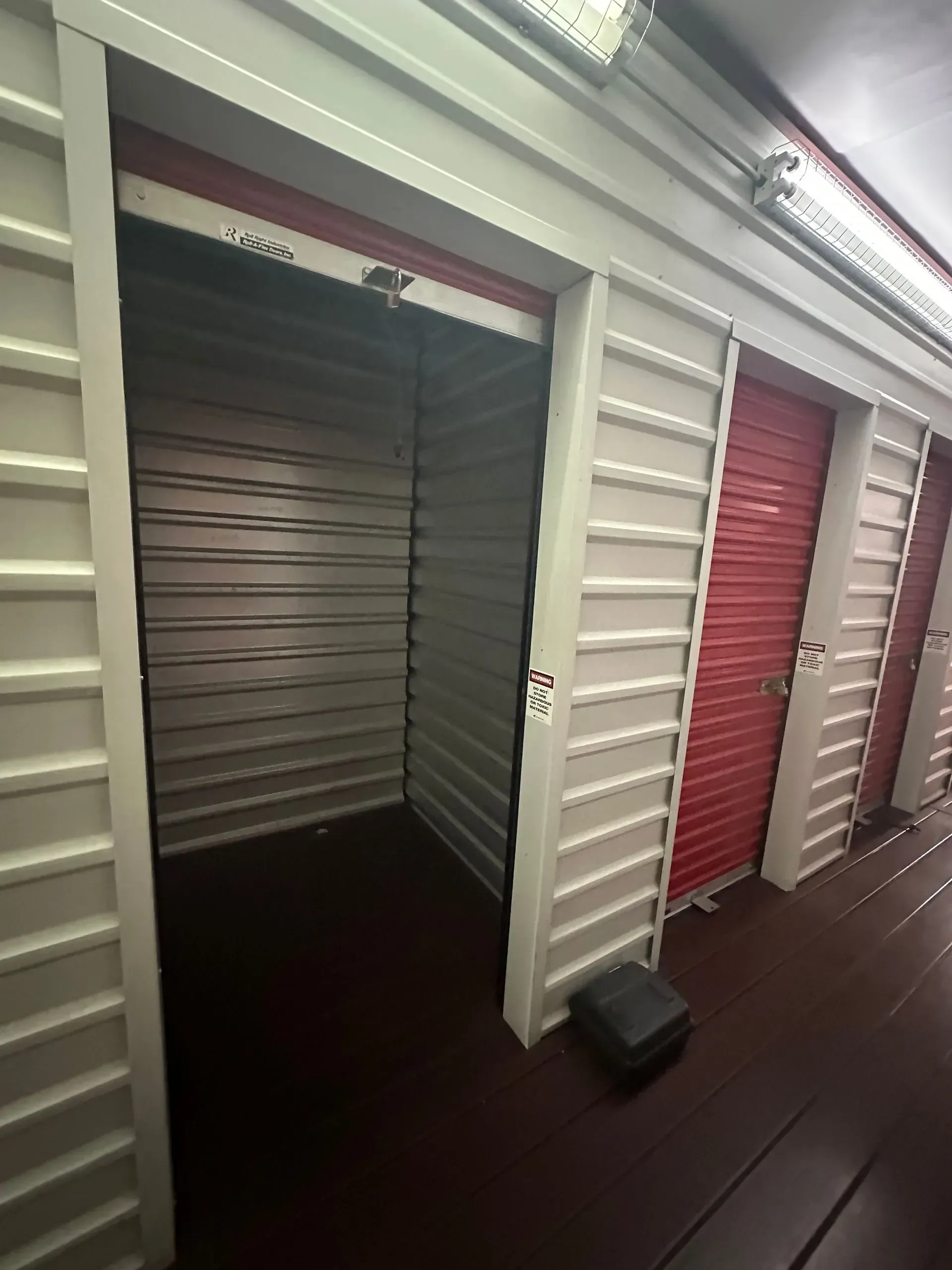 A row of empty storage units with red doors