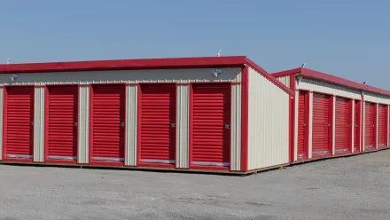 A row of red and white storage units with red doors