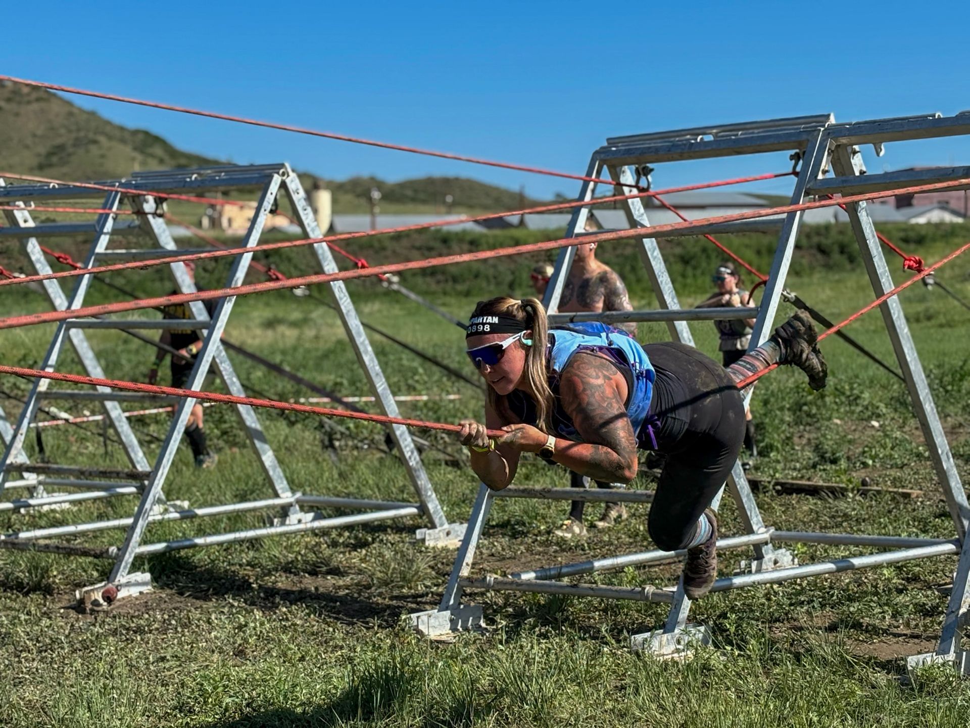 Female ninja navigating the Tyrollean traverse