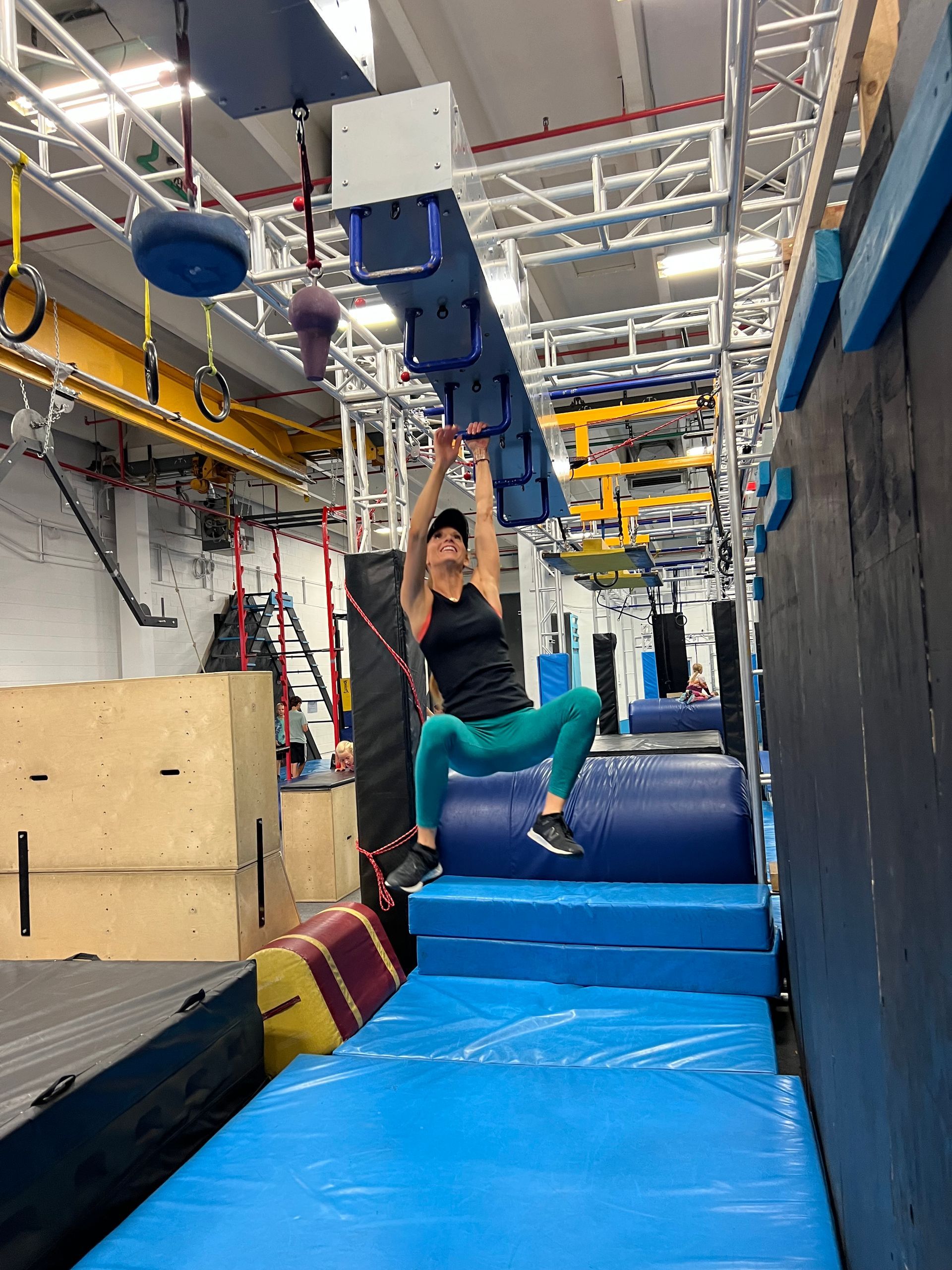 Female ninja navigating monkey bars