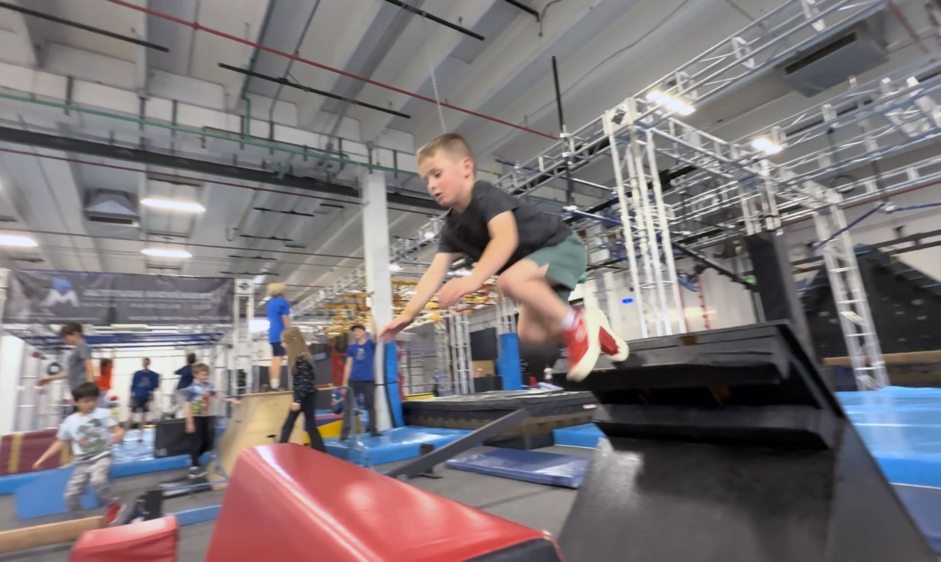 Boy vaulting in a ninja and parkour gym
