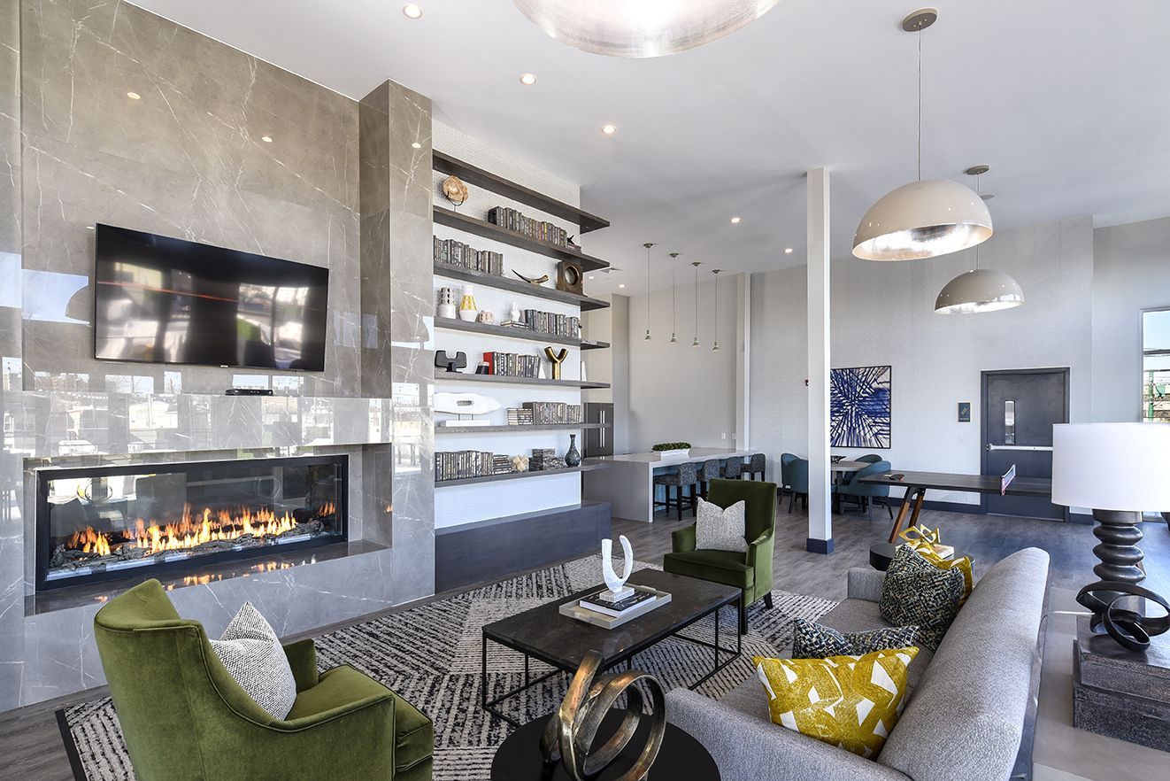 A rooftop patio with a lot of chairs and tables