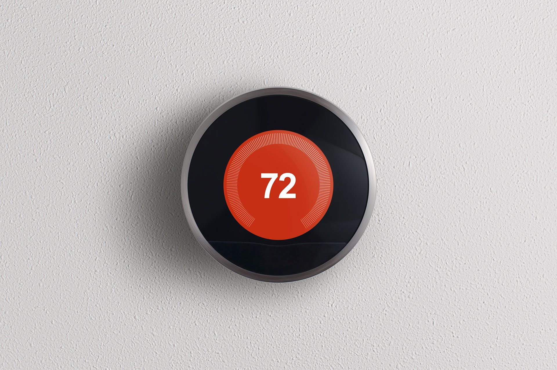 A smart thermostat with a red button that says 72 on it.