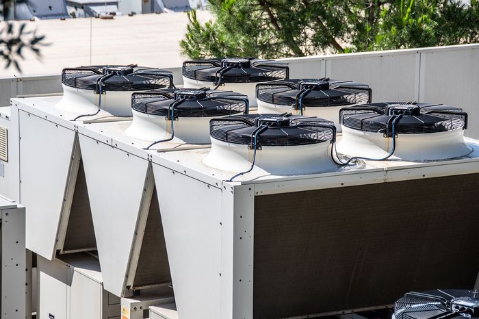 A bunch of fans are sitting on top of a building.