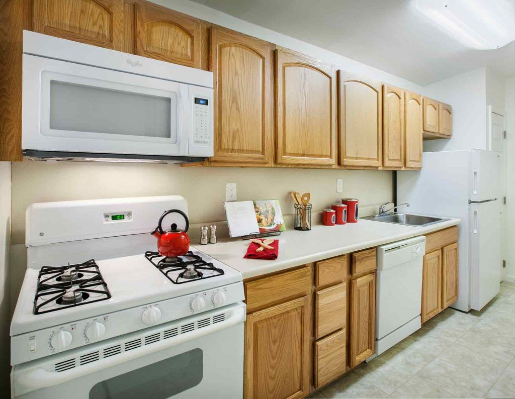Full kitchen with wood cabinets and gas stovetop