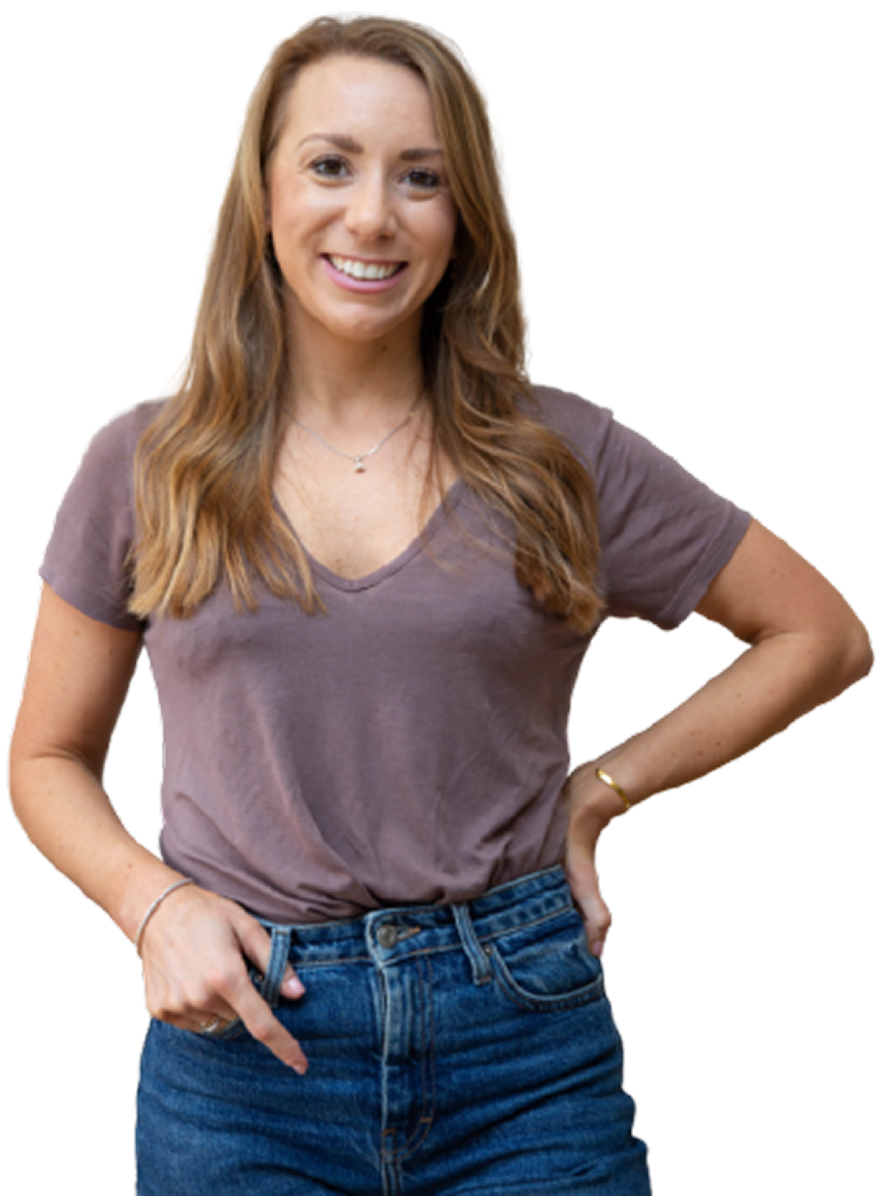 A woman wearing a purple t-shirt and blue jeans is pointing at herself.
