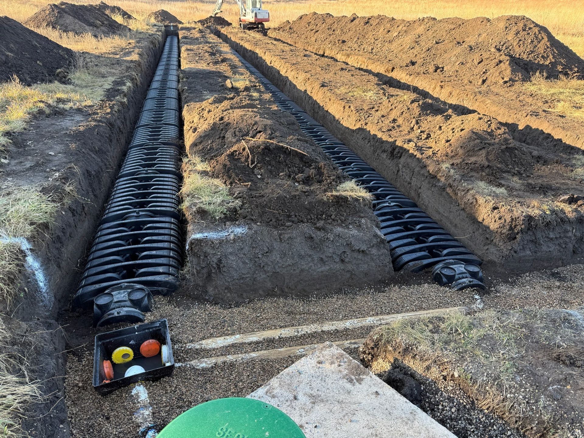 Water is coming out of two pipes on the side of a building.