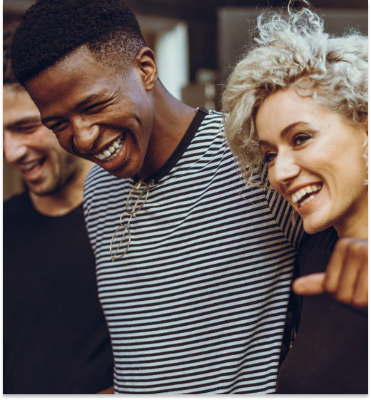 A group of people are laughing and pointing at the camera