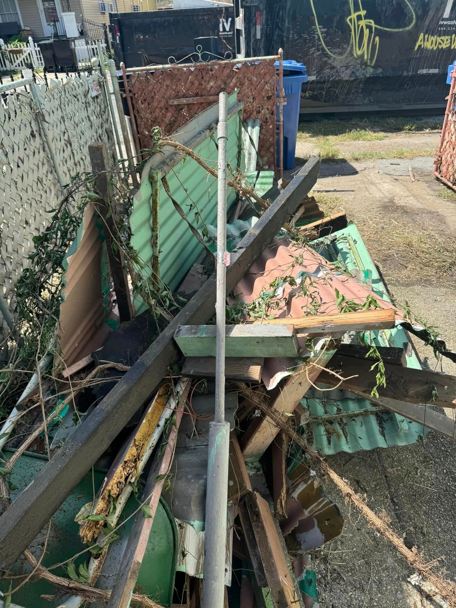 A pile of scrap metal is sitting on the ground in a yard.