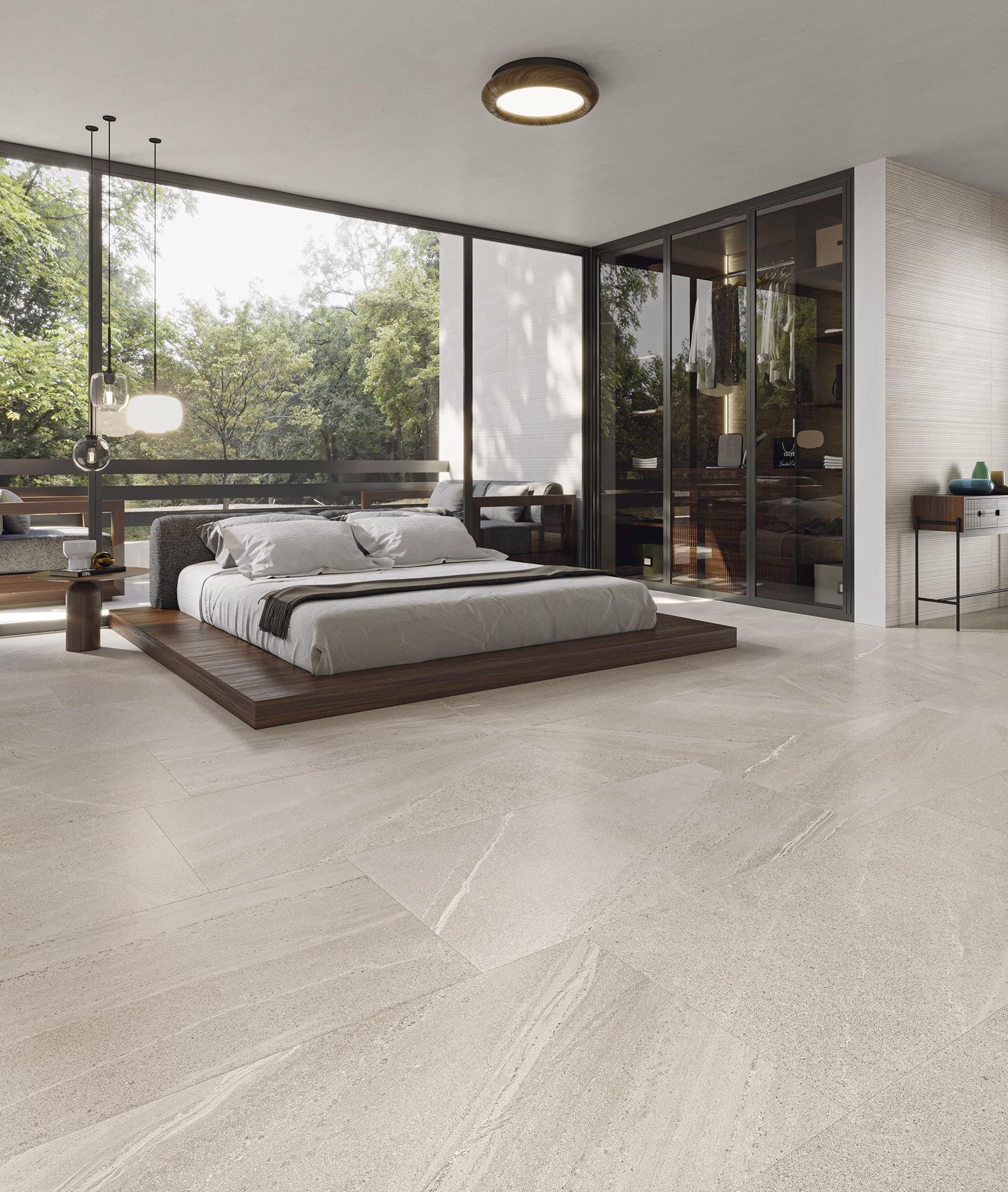 Svefnherbergi með stóru rúmi og stórum glugga.