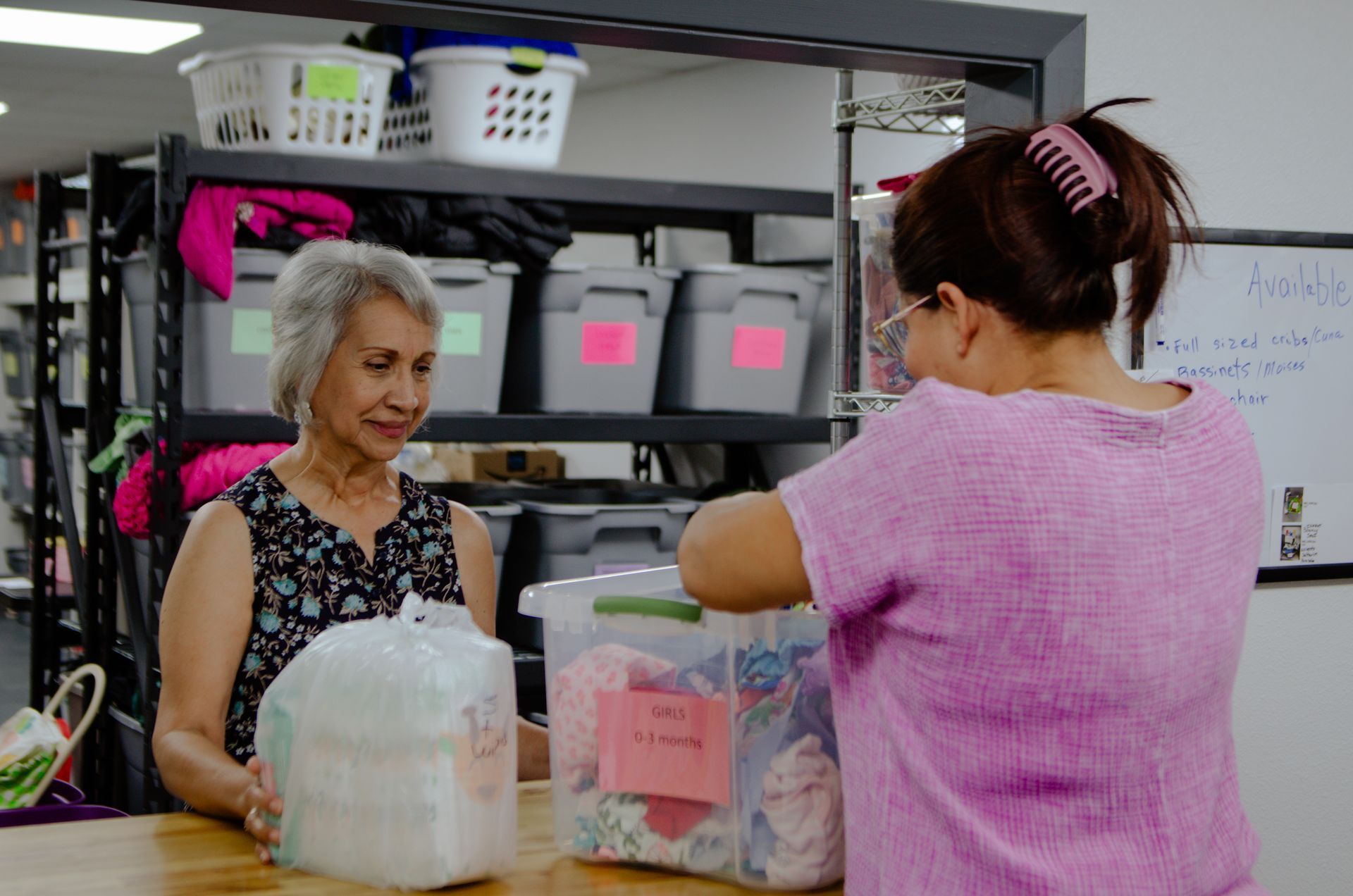 Two women are standing next to each other in a room.