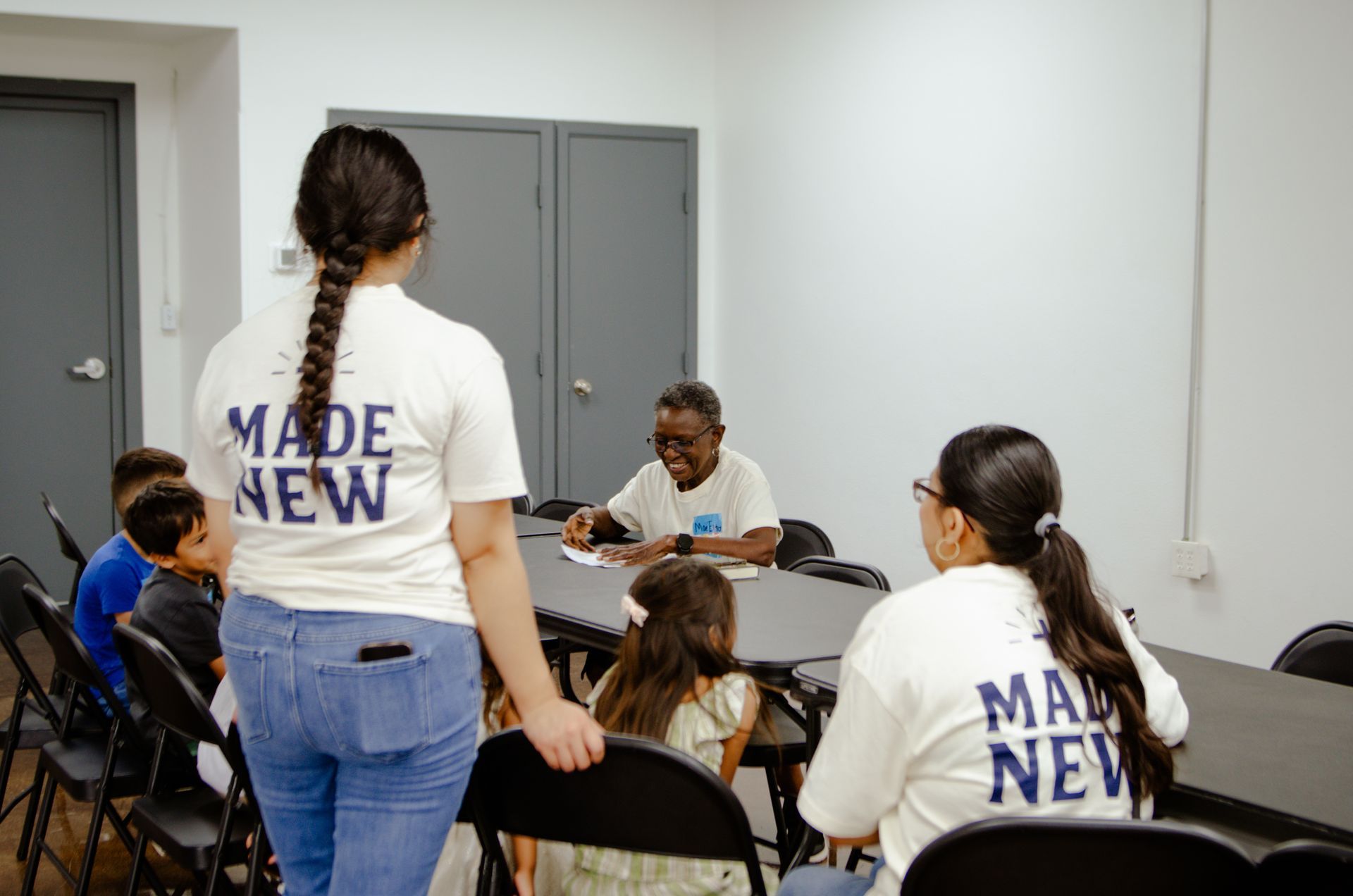 A group of people are sitting around a table in a room.