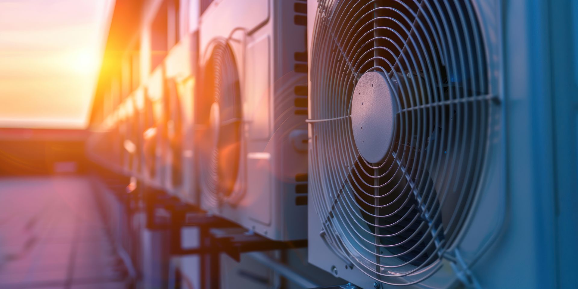 Black pergola with white curtains, two chairs, and small table on green grass.