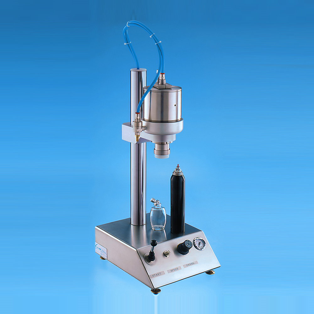 A pneumatic crimping machine for perfume bottles.