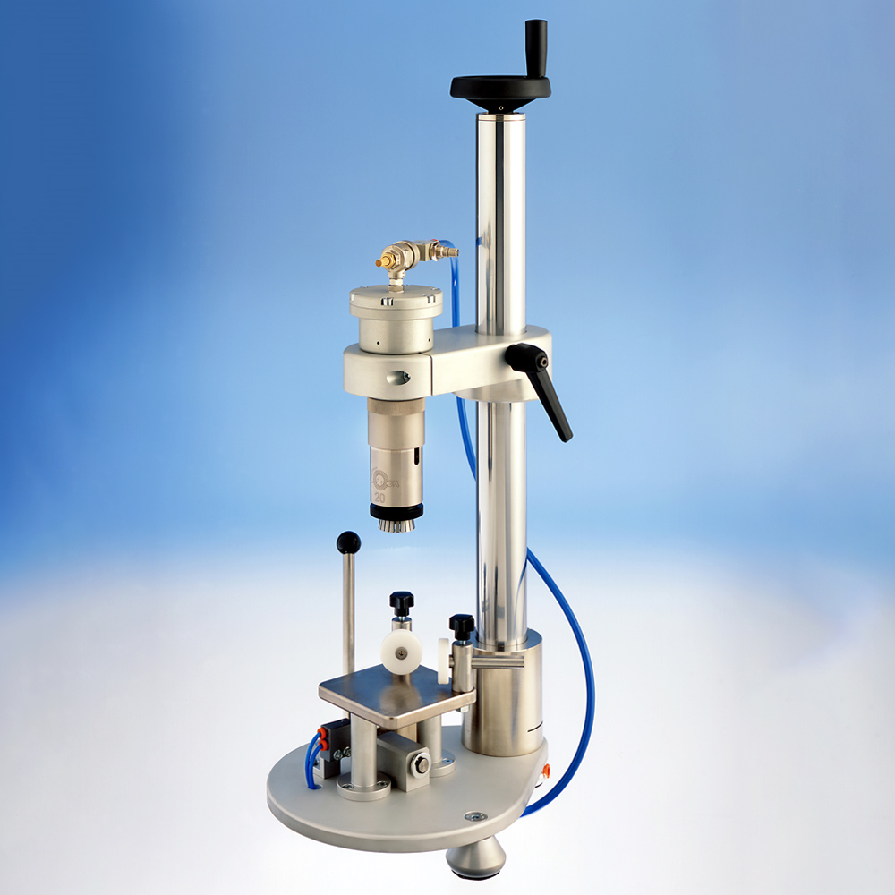 A benchtop laboratory crimping machine with a vertical stand.
