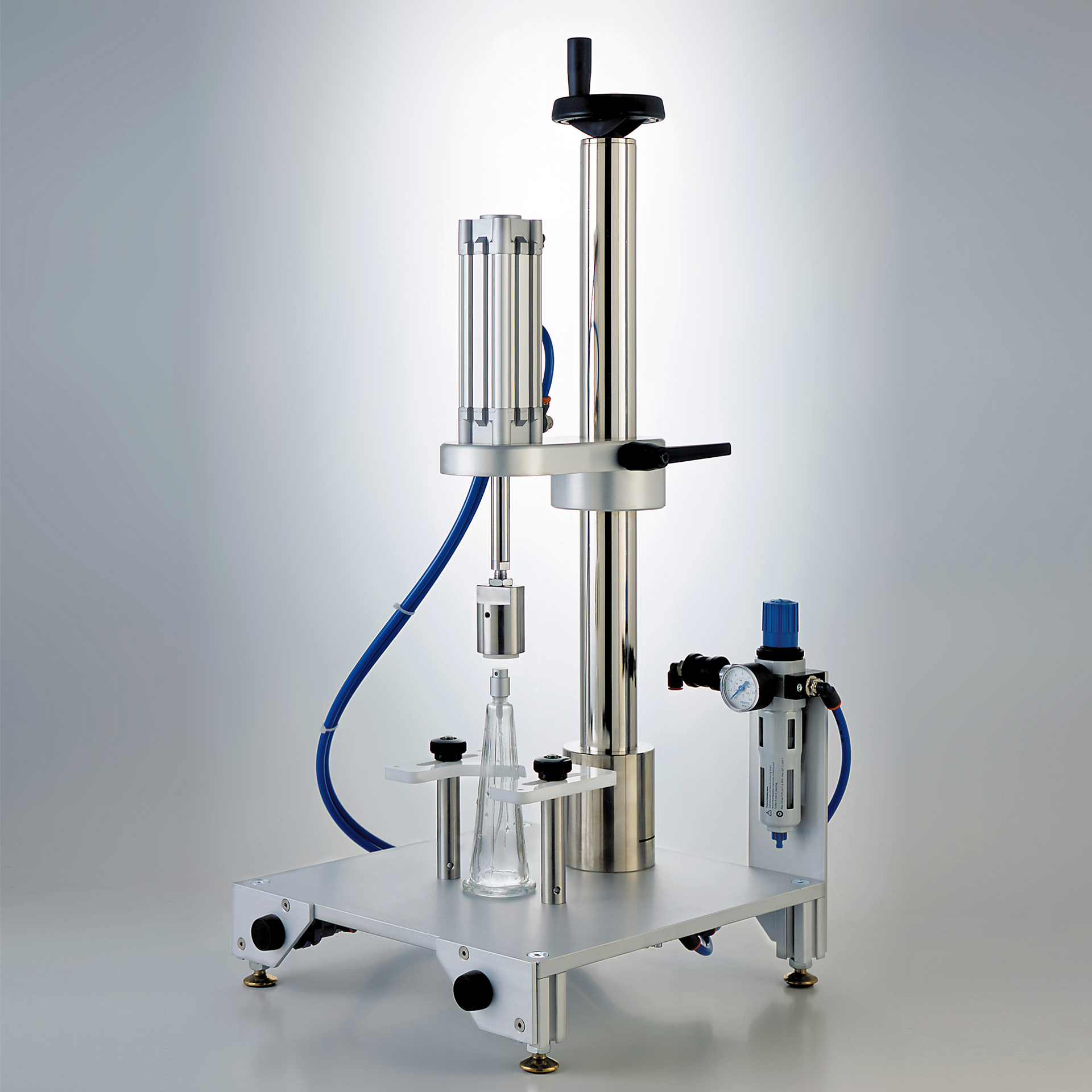 A pneumatic crimping machine on a metal stand with an air pressure regulator.