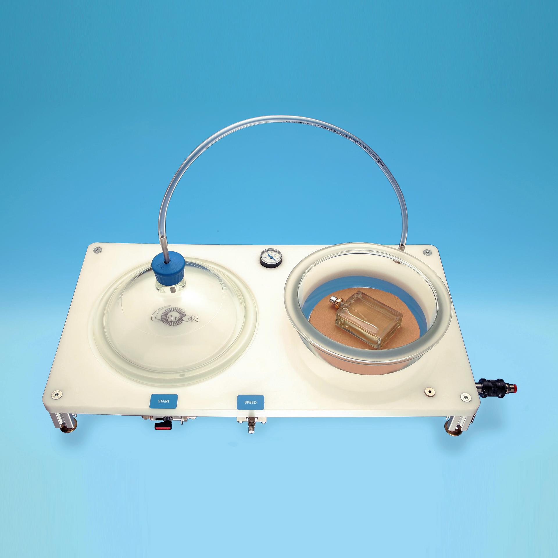 A laboratory leak-testing device with two chambers on a white base.