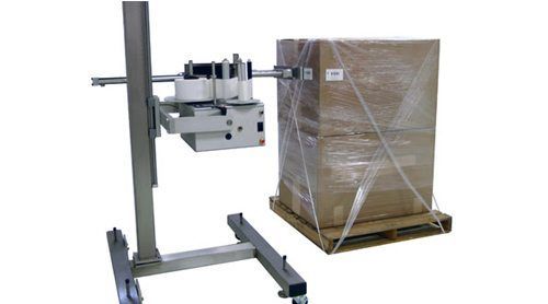 A pallet labeler machine stands next.