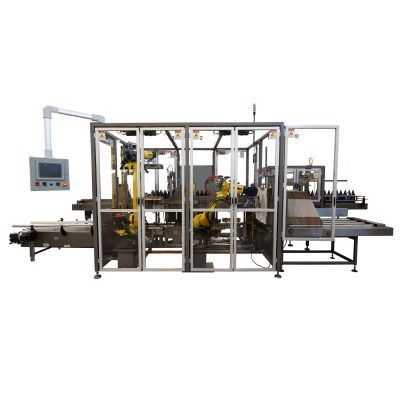 An industrial robotic packaging system with yellow mechanical arms inside a protective enclosure on a factory floor.