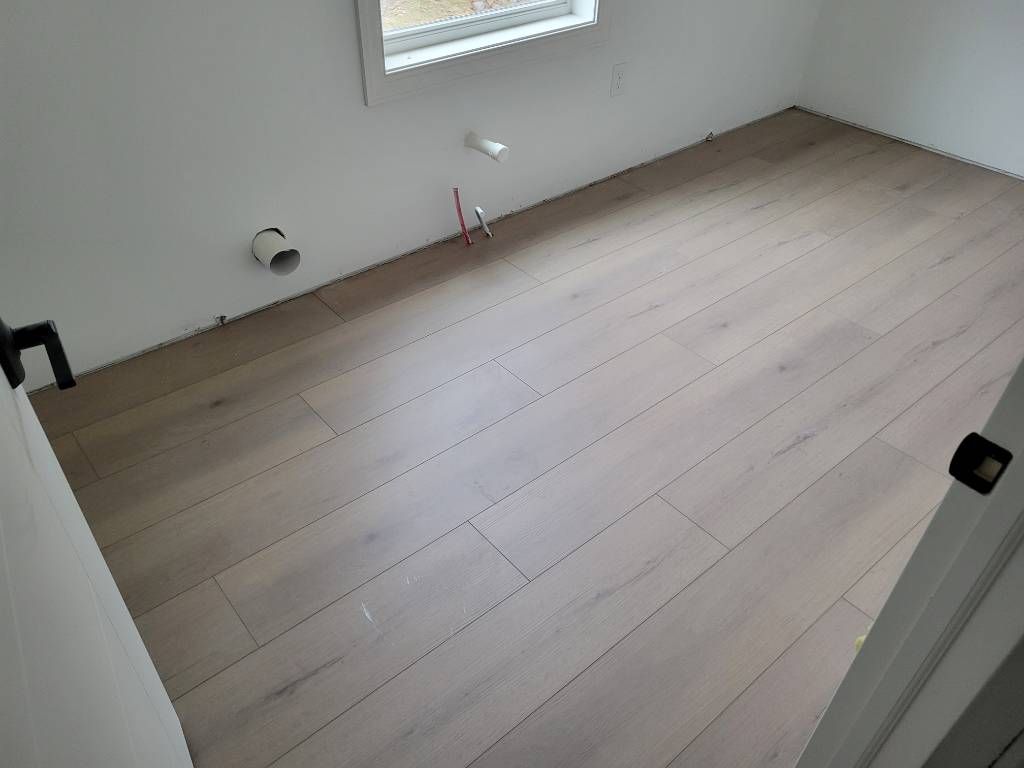 A room with a hardwood flooring by Floor Source