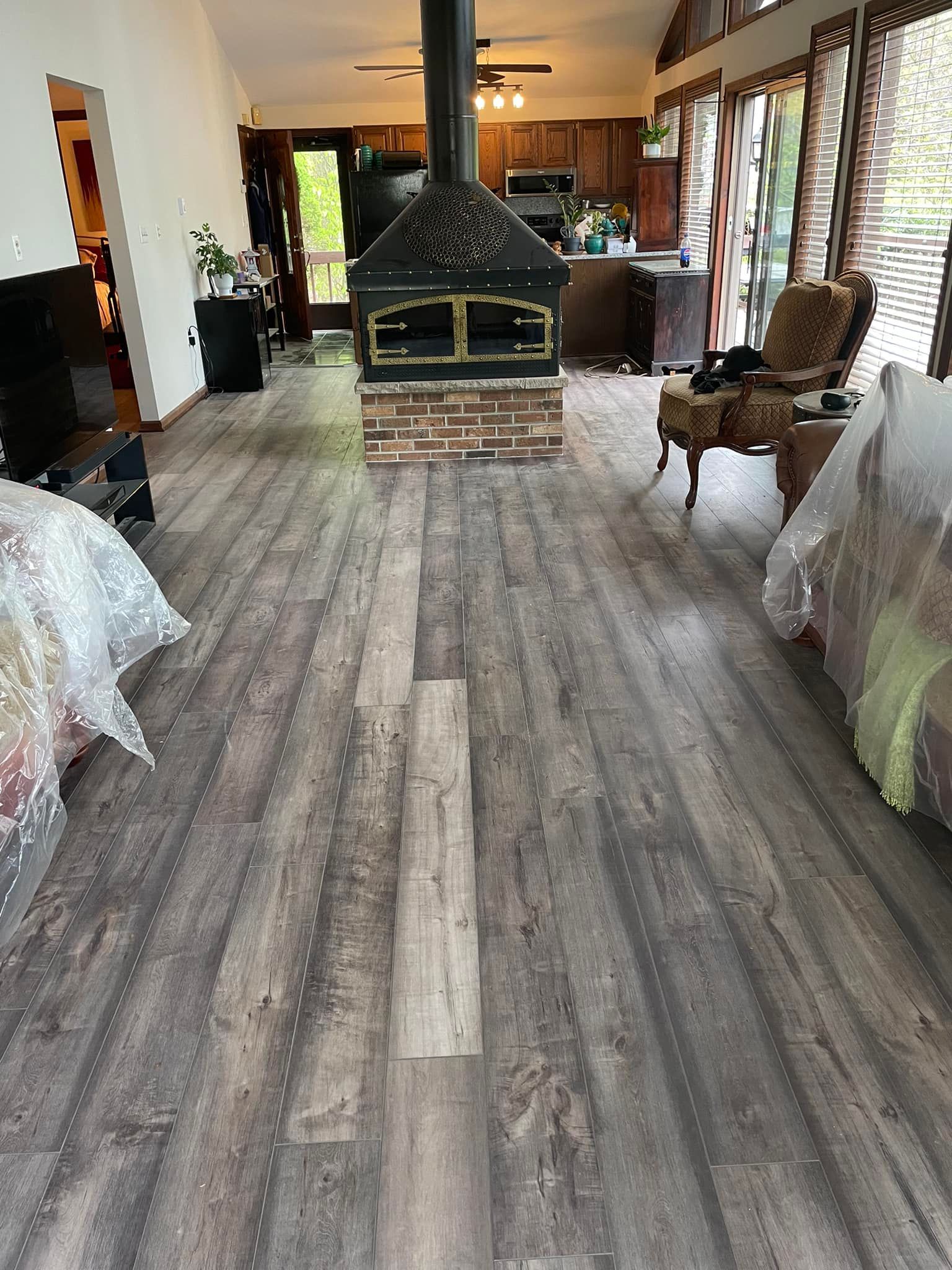 A living room with hardwood floors by Floor Source