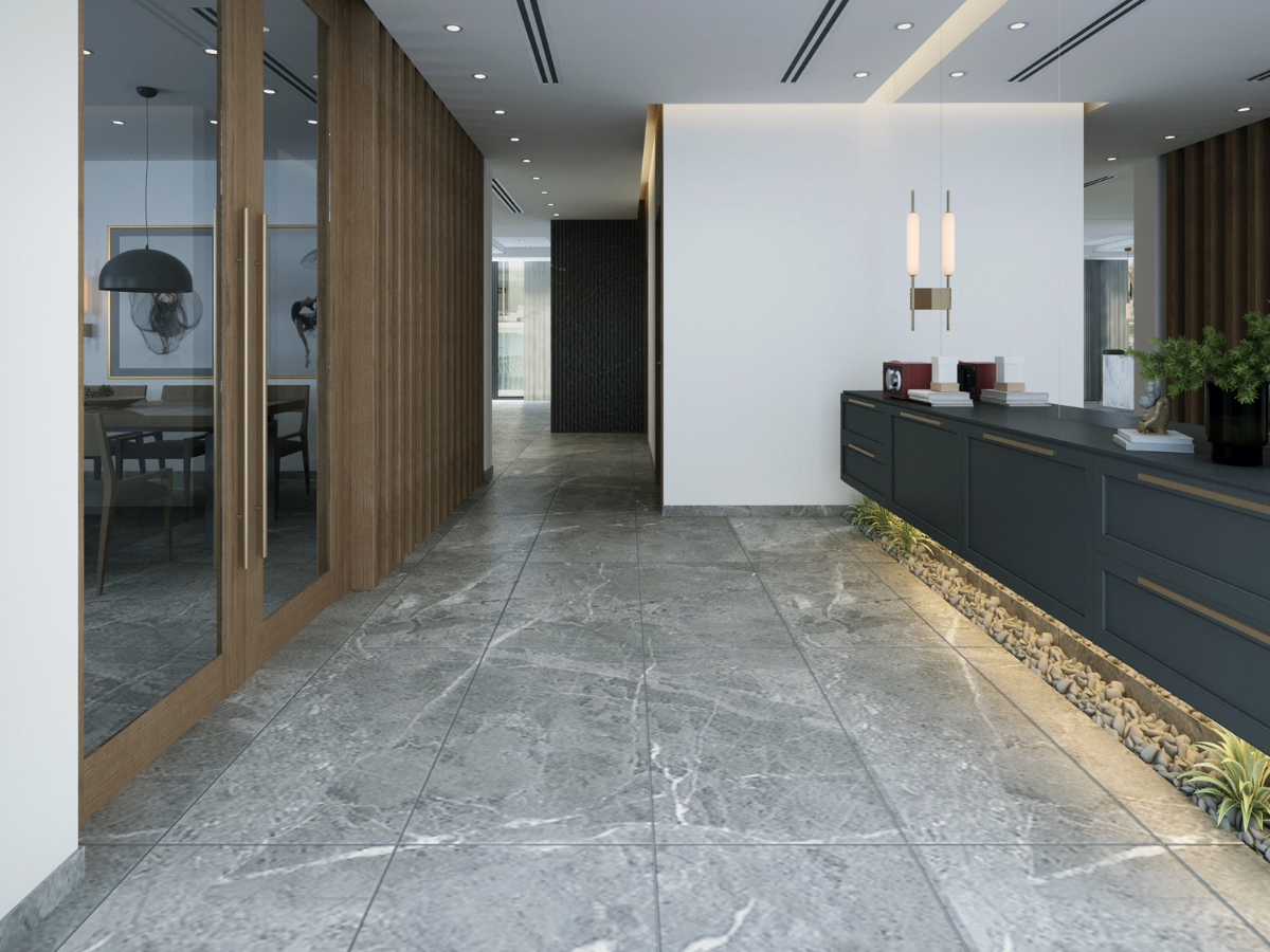 A hallway with a marble floor and a black counter