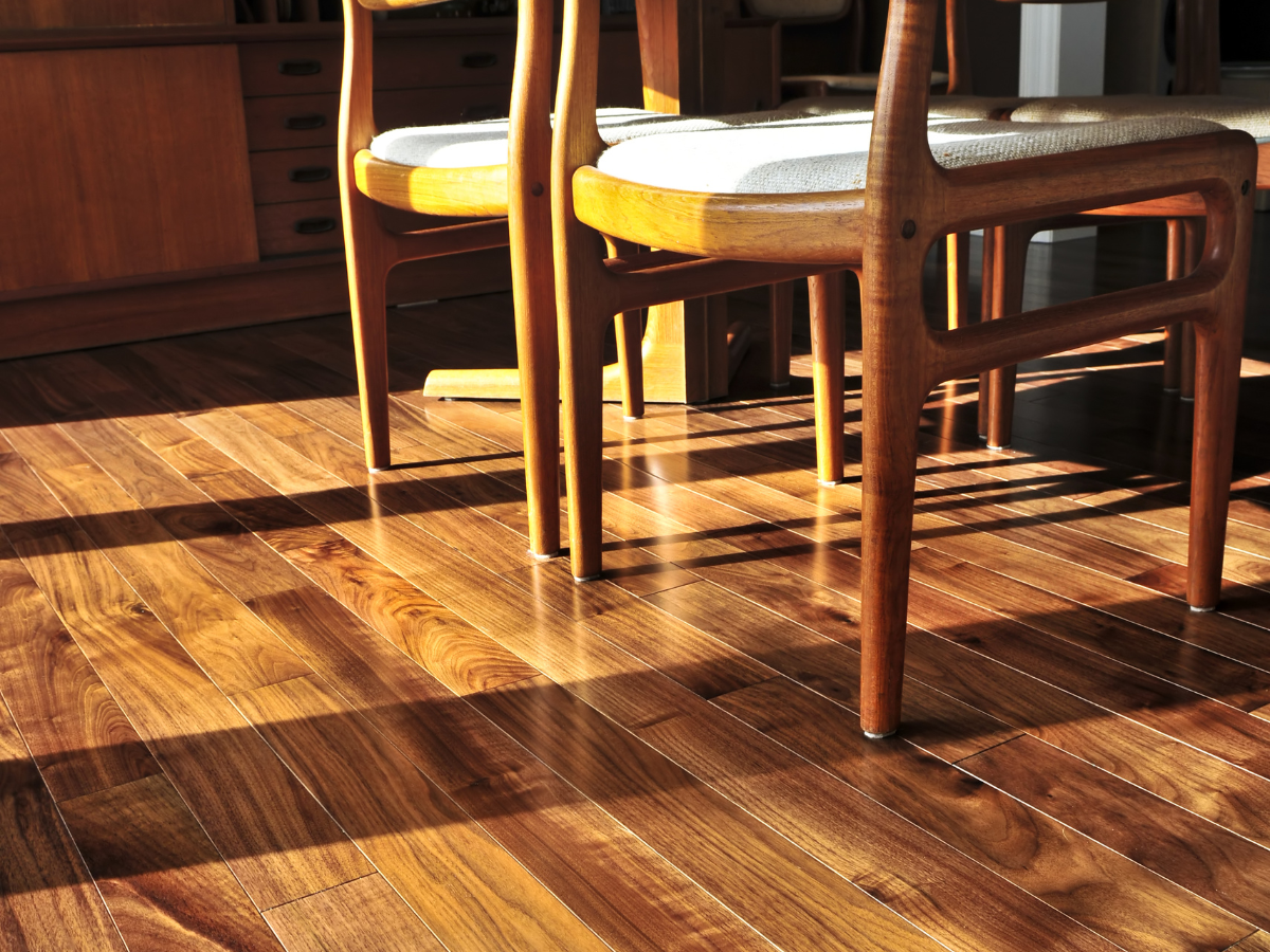 A wooden floor with a few chairs on it