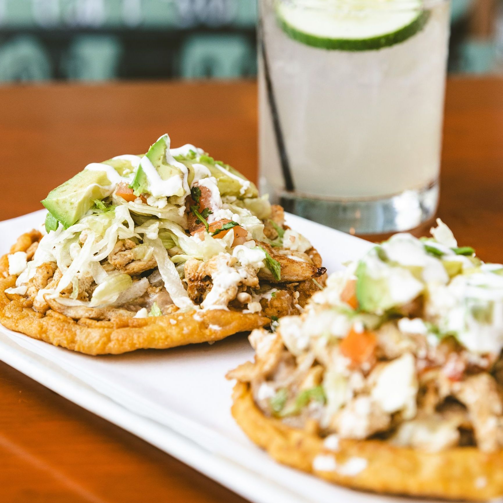 A plate of food with a drink in the background