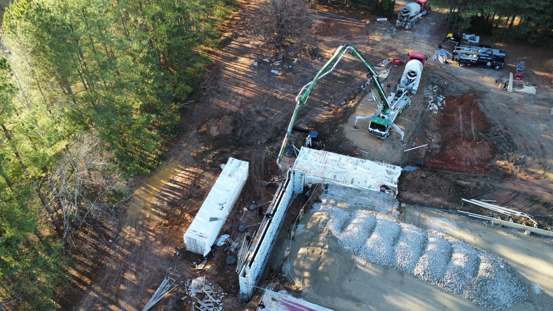 An aerial view of a construction site with a concrete pump.